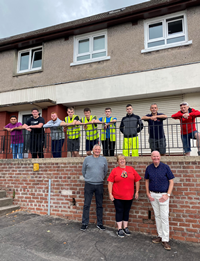 Trainees and staff from Inverclyde Community Development Trust and councillors Michael McCormick and Jim McEleny with residents of Bridgend Road in Greenock which has been spruced up thanks to a 'Future Jobs' programme funded by Inverclyde Council and delivered by The Trust.